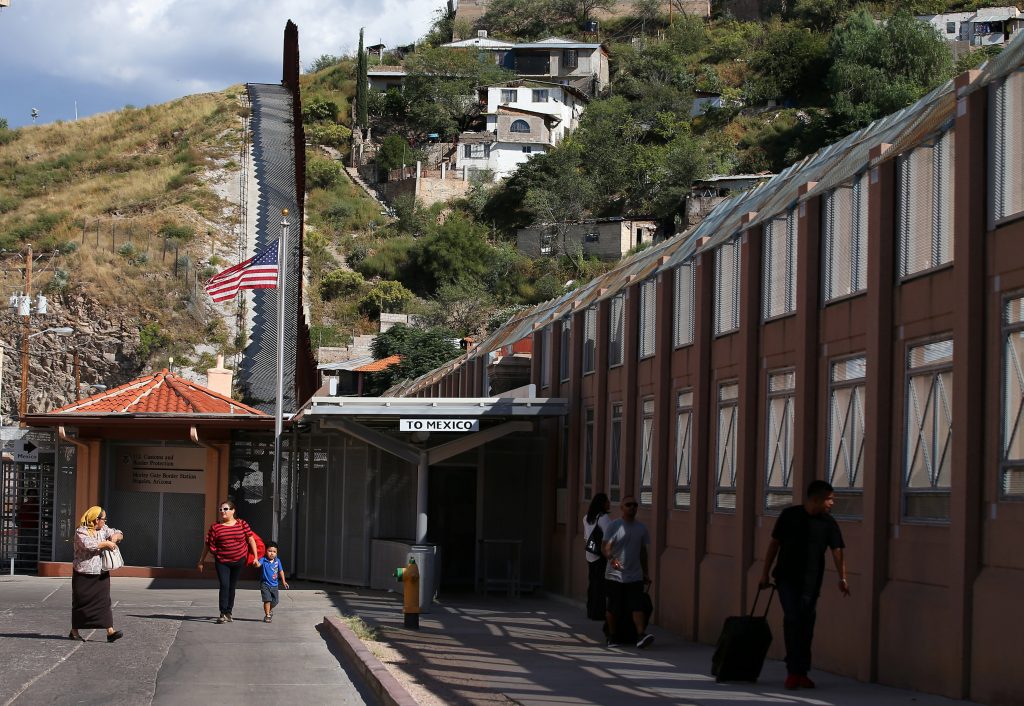 Pedestres vindos do México caminham em território americano depois de cruzarem a fronteira em Nogales, no Arizona (FOTO: REUTERS/Mike Blake)
