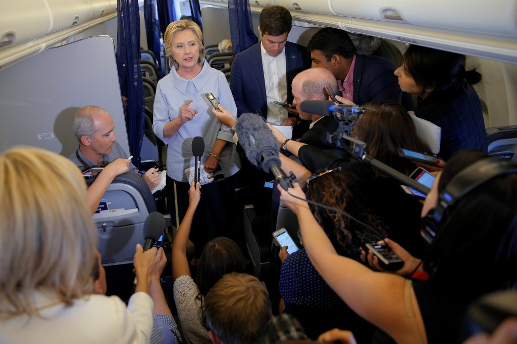 U.S. Democratic presidential candidate Hillary Clinton answers questions from reporters on her campaign plane enroute to a campaign stop in Moline, Illinois, United States September 5, 2016. REUTERS/Brian Snyder