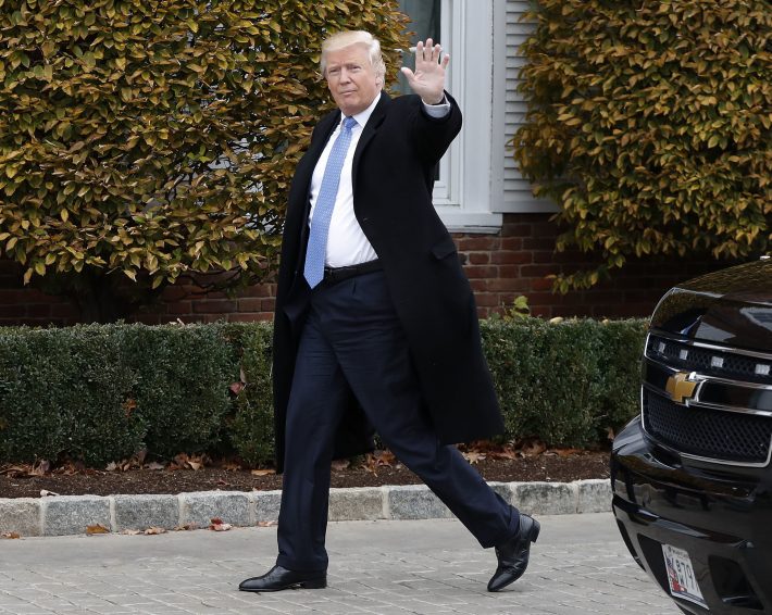 FILE - In this Nov. 20, 2016 file photo, President-elect Donald Trump waves as he arrives at the Trump National Golf Club Bedminster clubhouse in Bedminster, N.J. Thousands of high school students from Seattle to Silver Spring, Md., have taken to the streets since Trump's election to protest his proposed crackdown on illegal immigration and his rude comments about women. (AP Photo/Carolyn Kaster, File)