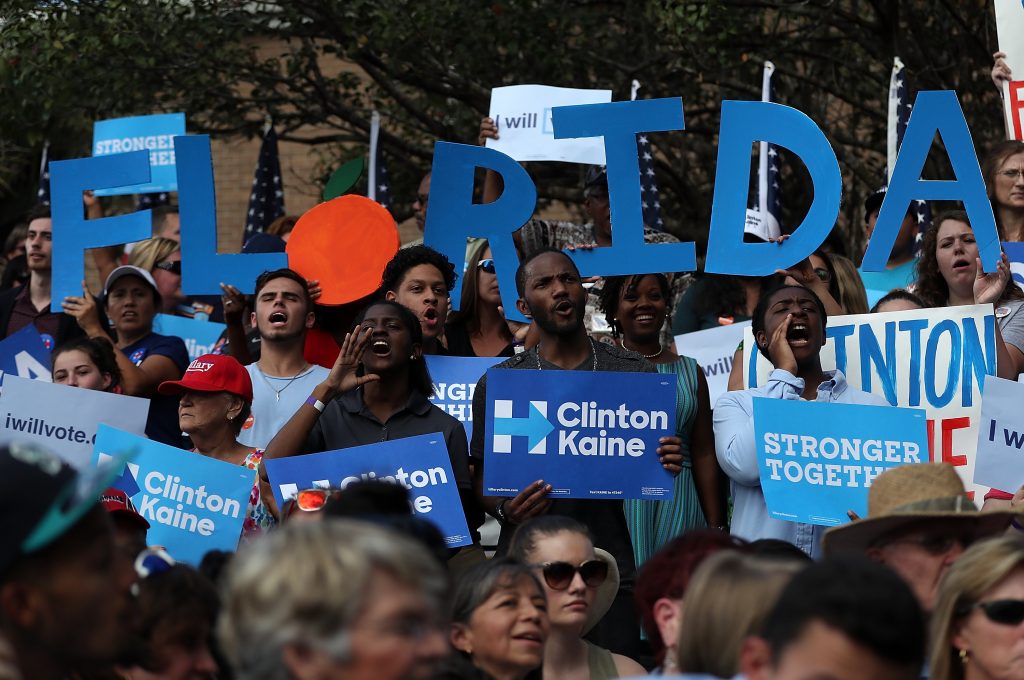 DADE CITY, FL - NOVEMBER 01: Supporters cheer as Democratic presidential nominee former Secretary of State Hillary Clinton speaks during a campaign rally at Pasco-Hernando State College East Campus on November 1, 2016 in Dade City, Florida. With one week to go until election day, Hillary Clinton is campaigning in Florida. Justin Sullivan/Getty Images/AFP == FOR NEWSPAPERS, INTERNET, TELCOS & TELEVISION USE ONLY ==