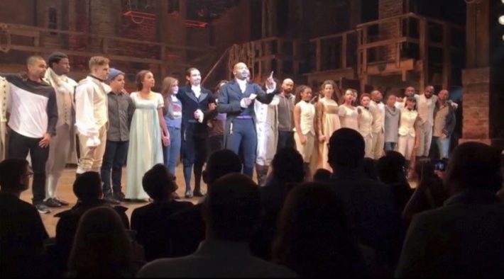 In this image made from a video provided by Hamilton LLC, actor Brandon Victor Dixon who plays Arron Burr, the nation’s third vice president, in "Hamilton" speaks from the stage after the curtain call in New York, Friday, Nov. 18, 2016. Vice President-elect Mike Pence is the latest celebrity to attend the Broadway hit "Hamilton," but the first to get a sharp message from a cast member from the stage. (Hamilton LLC via AP)