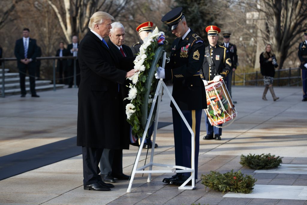 President-elect Donald Trump, accompanied by Vice President-elect Mike Pence places a wreath at the Tomb of the Unknowns, Thursday, Jan. 19, 2017, at Arlington National Cemetery in Arlington, Va., ahead of Friday's presidential inauguration. (AP Photo/Evan Vucci)