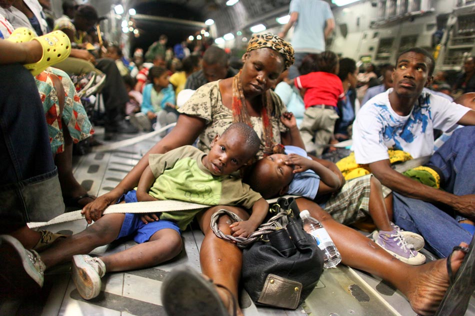 Enette Dumerin e seus filhos gêmeos deixam o país, rumo aos EUA. Porto Príncipe, Haiti. 17/01/2010. Foto: Joshua Trujillo/AP