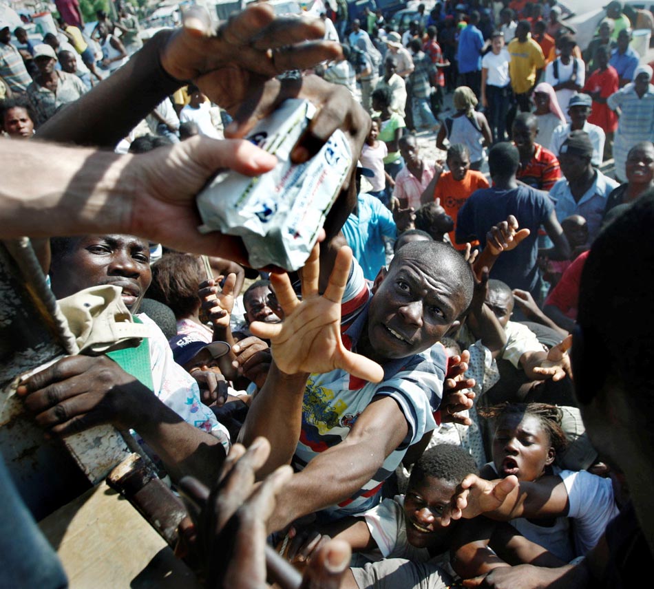 Haitianos lutam por alimentos em Petionville, Porto Príncipe, Haiti. 17/01/2010. Foto: Carl Juste/The Miami Herald/AP