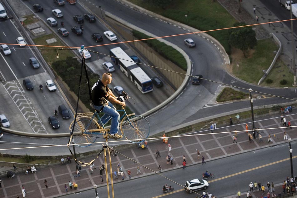 Por um fio: Acrobata atravessa o Vale do Anhangabaú em uma bicicleta, a 120 metros de altura, para divulgar a série de televisão 9MM. São Paulo, 13/05/09. Foto: André Lessa/AE