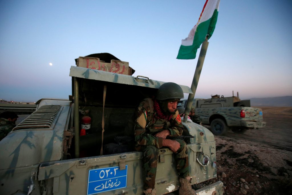 A member of Peshmerga forces sits in the back of the military vehicle in the east of Mosul during operation to attack Islamic State militants in Mosul, Iraq, October 17, 2016. REUTERS/Azad Lashkari
